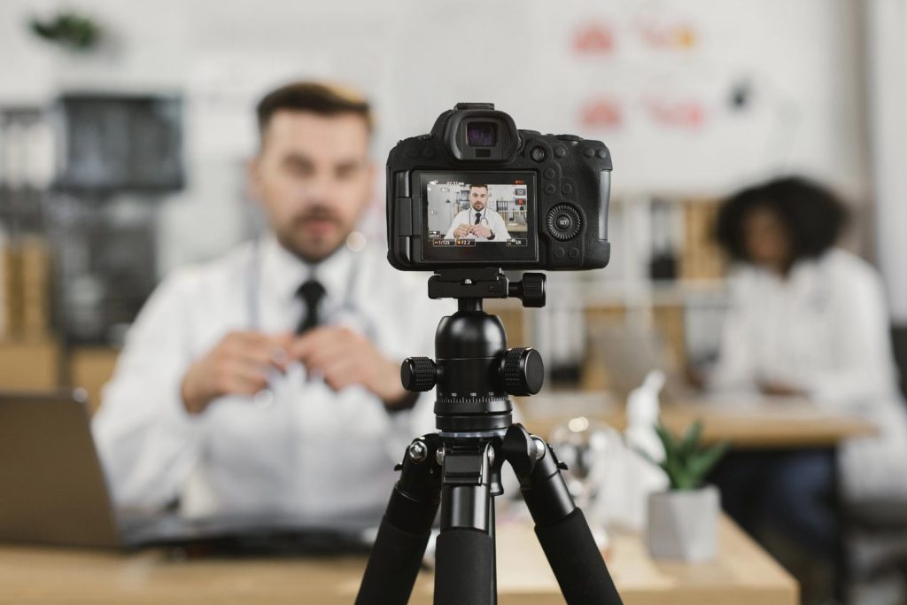 Dentist recording a professional dental video with a camera, highlighting dental videos production in Sugar Land.