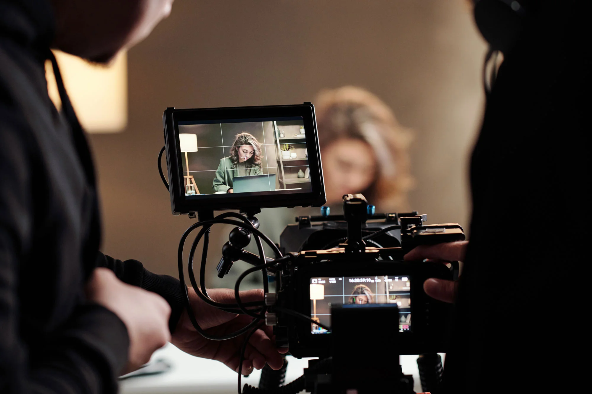 A crew from a commercial video production company filming a scene with a professional camera and monitor.