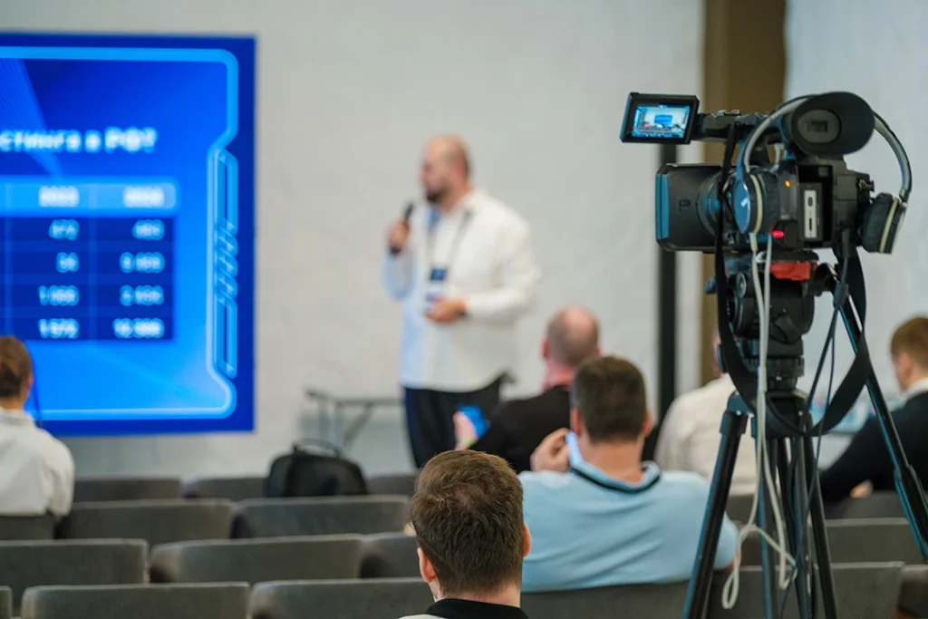 Corporate video production company Sugar Land: Cameraman capturing executive speech at UTurn Productions, producing high-quality corporate content in Sugar Land.