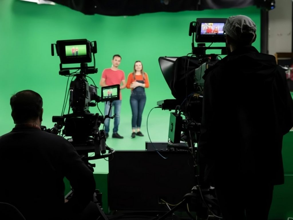 Expert corporate video production company in Sugar Land recording on a green screen with multiple cameras for high-quality corporate video content.