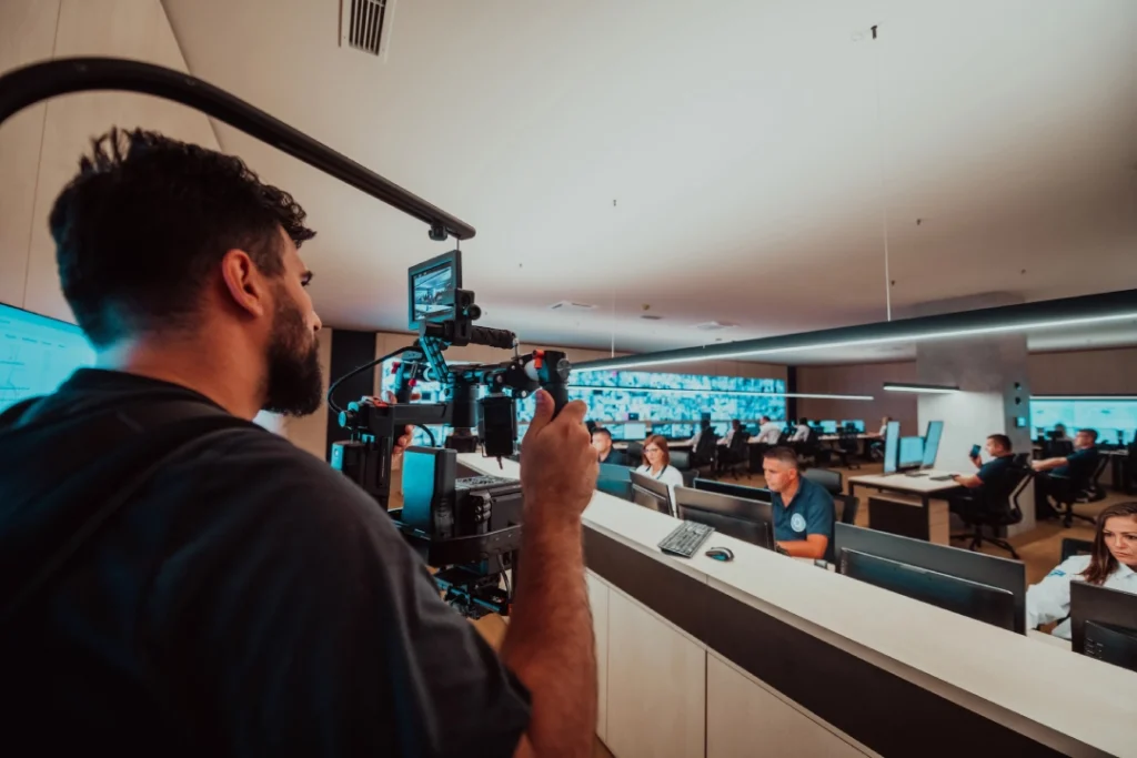 Team documents control room operations for corporate video production Sugar Land using stabilizer rig and pro camera gear.