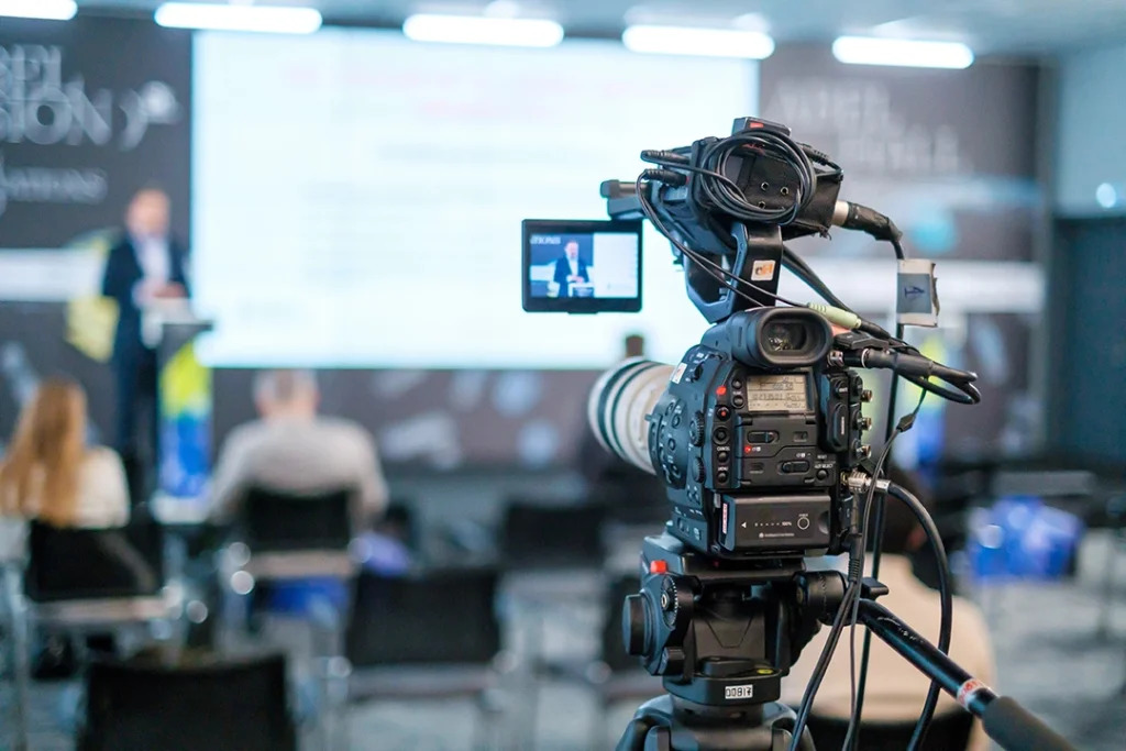 Corporate video production agency Sugar Land: Team filming corporate event at UTurn Productions with professional cameras and lighting setup.