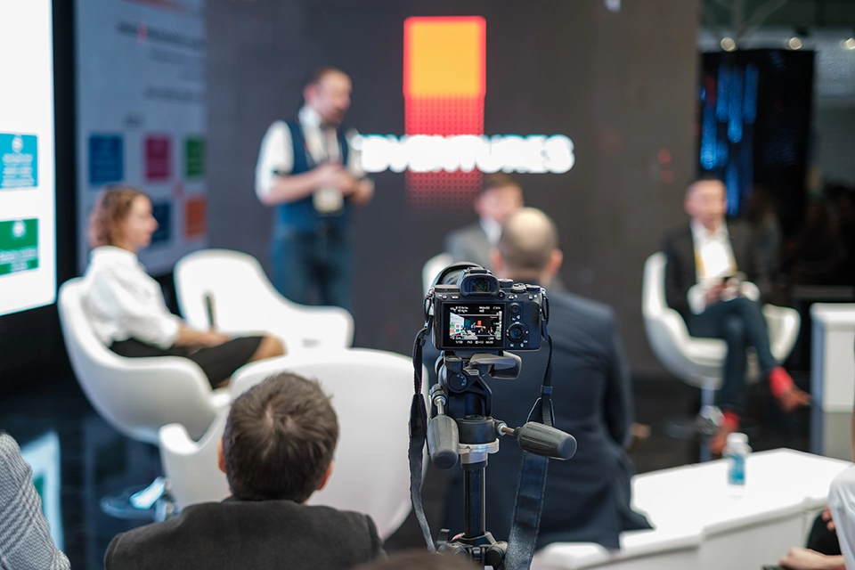 Corporate video production company Sugar Land: Crew filming corporate interview in modern office at UTurn Productions, with professional lighting and equipment.