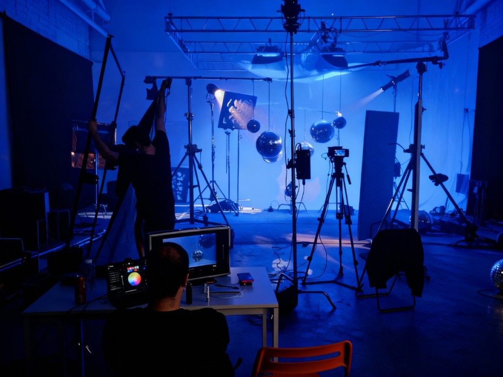 Dynamic corporate video production agency in Sugar Land with a professional crew setting up advanced lighting and camera gear for top-tier video content.