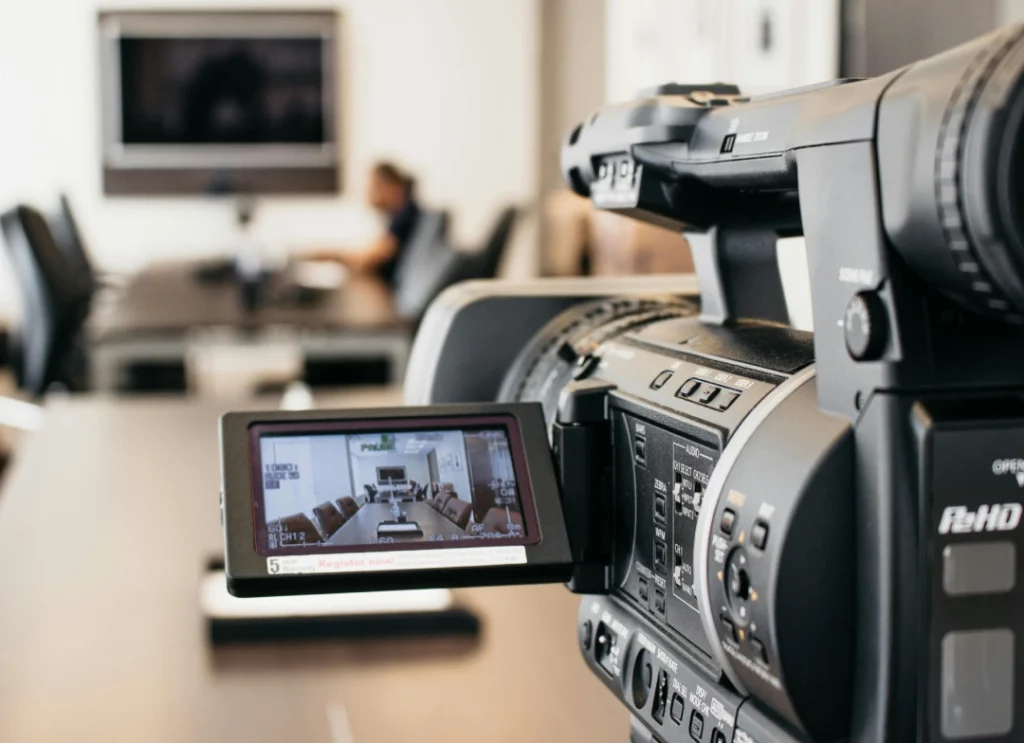Professional camcorder recording a corporate conference room; your expert corporate video production agency Sugar Land.