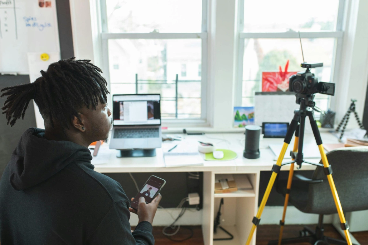 Man managing a live stream setup with a professional camera tripod—ideal project for a corporate video production agency Sugar Land.