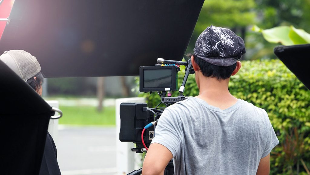 Outdoor film crew setting up professional gear for promotional videos production Sugar Land marketing.