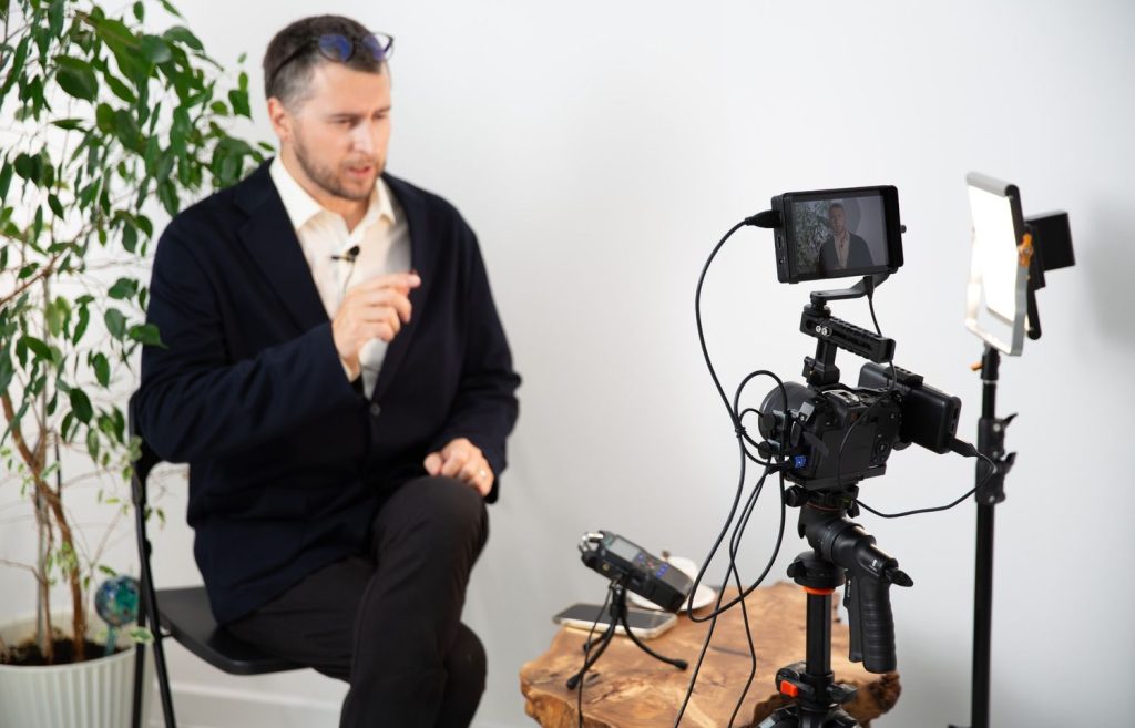 A speaker records a presentation with a corporate video production company Sugar Land using LED lights and lapel mics.