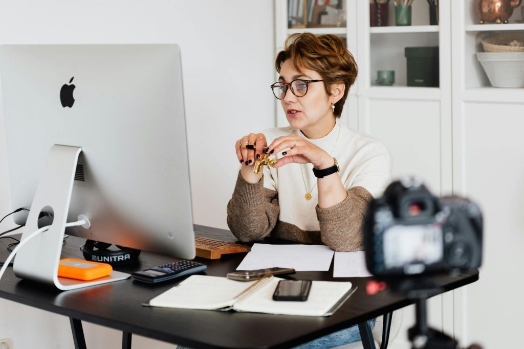 Expert filming a corporate interview for business videos production Sugar Land at a professional desk setup.
