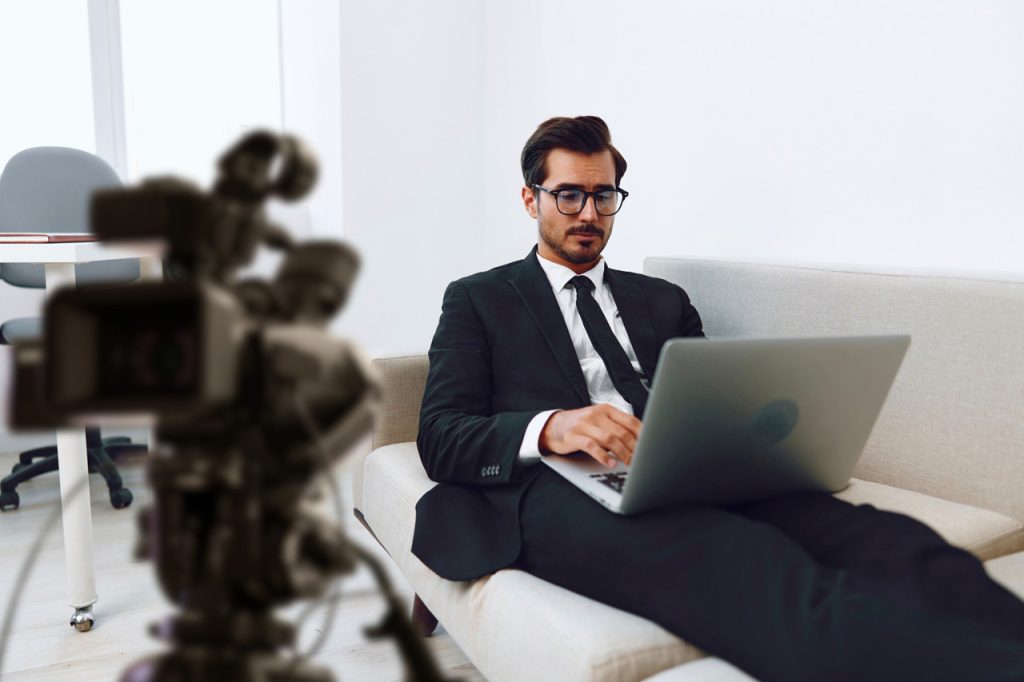 A corporate video production agency Sugar Land filming a professional executive interview with a high-end cinema camera.