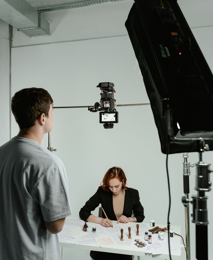 Behind-the-scenes view of a professional studio setup with overhead cameras and lighting for clients ready to hire a business video agency in Sugar Land.