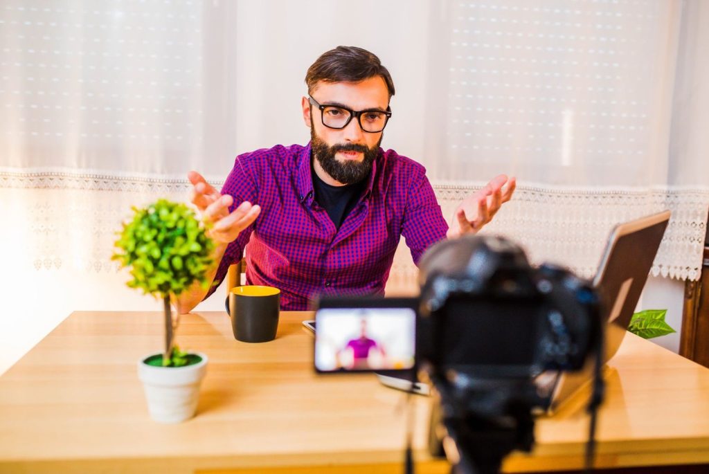 A man recording a marketing vlog for a commercial video production company Sugar Land to boost brand engagement.