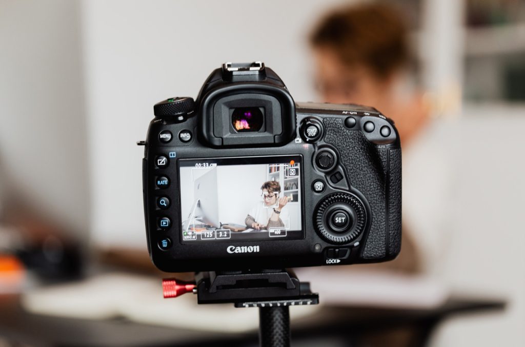 Behind the scenes of a corporate video production company Sugar Land crew filming high-quality DSLR video on location.