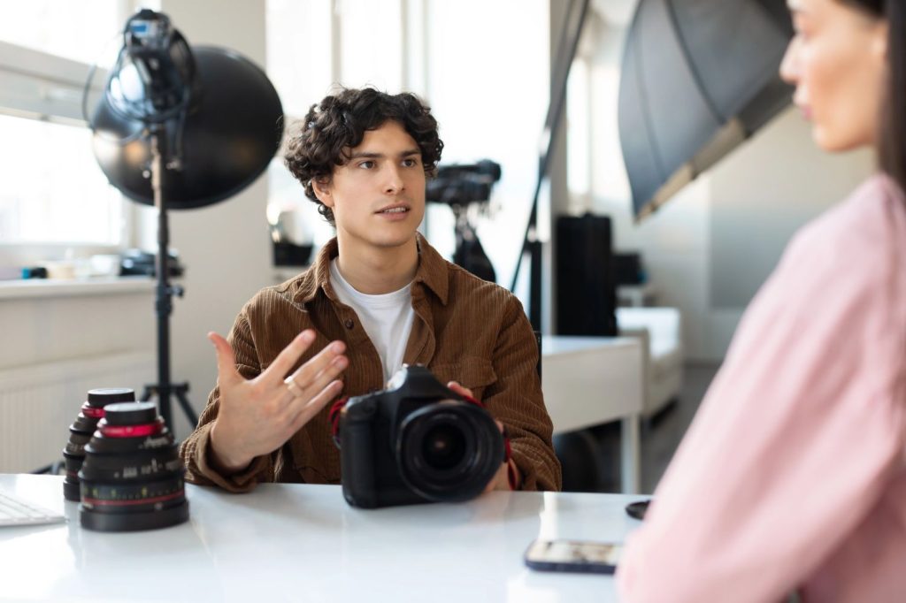 Creative director at a corporate video production agency Sugar Land discussing lens options for a professional shoot.