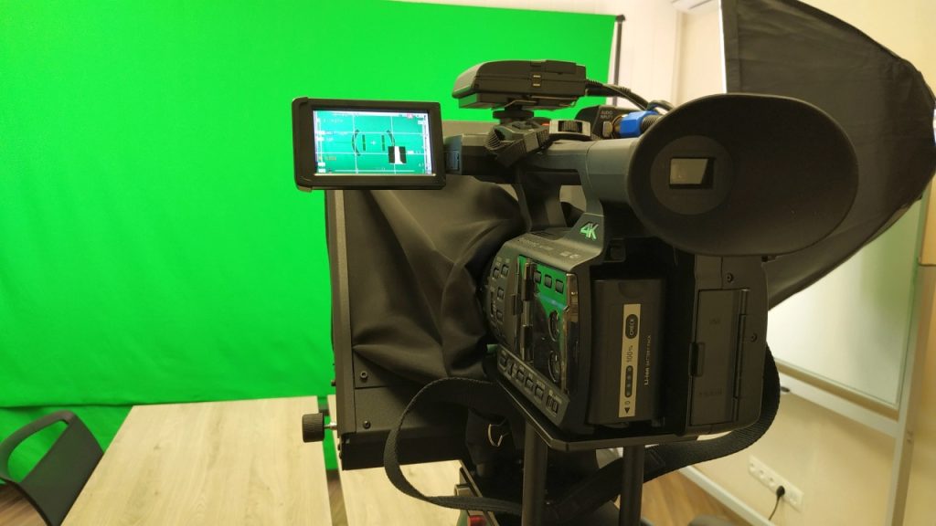 Professional 4K camera setup for film production Sugar Land in a green screen studio with professional studio lighting.