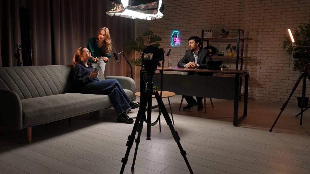 Professional corporate video production Sugar Land studio set featuring an interview with lighting and cameras.