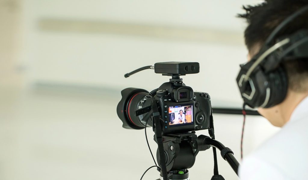 Professional interview filming by a commercial video production company Sugar Land, featuring a DSLR camera on a tripod.