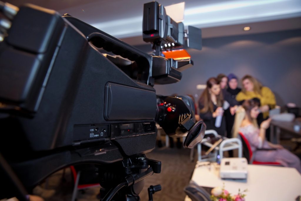 Professional camera filming a live event for a top-rated corporate video production company Sugar Land specialist.