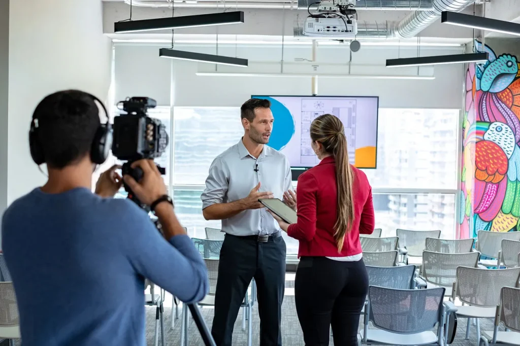 Corporate video production company Sugar Land filming a male professional giving a business presentation in a modern office.
