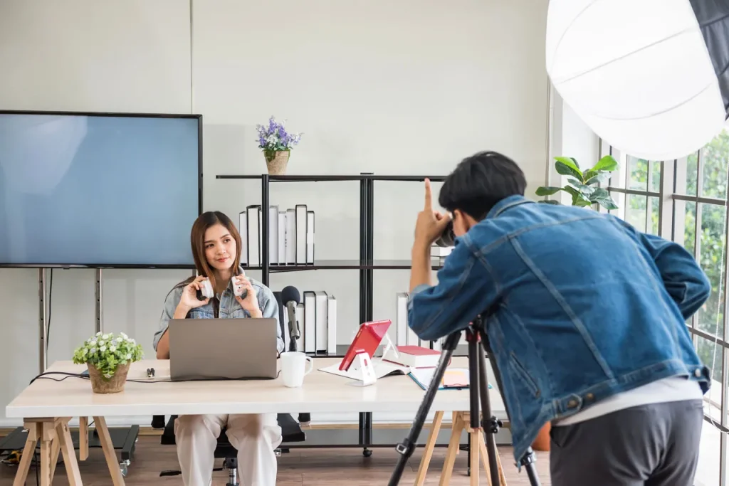 Content creator at a desk for a corporate video production company Sugar Land, recording a podcast with professional gear.