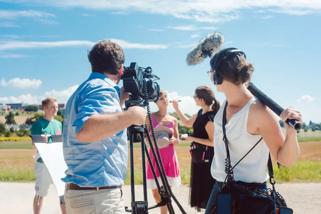 Full on-location commercial shoot by a video production company sugar land, featuring camera, boom audio, and reflectors.