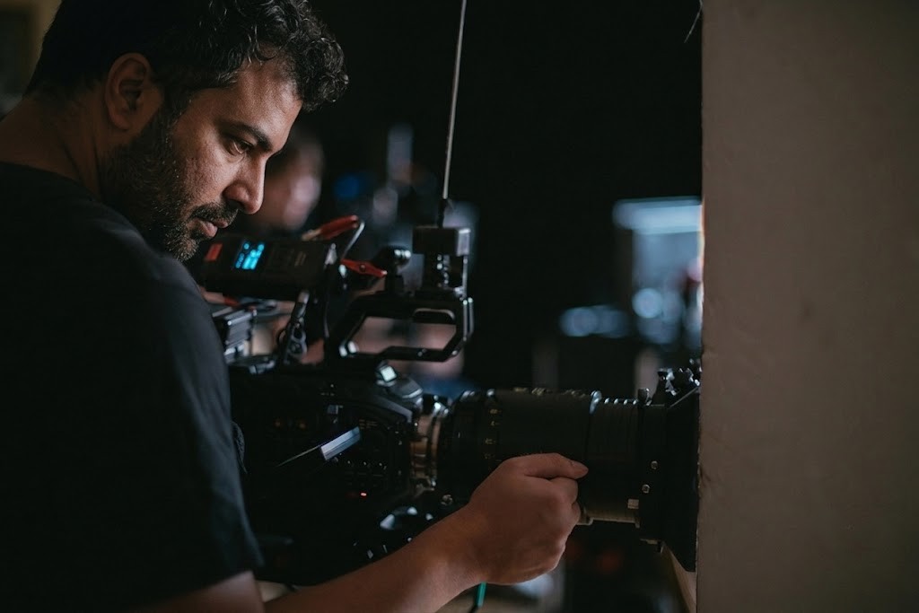 A cameraman operating a professional camera rig on set, a service by our corporate video production agency sugar land.