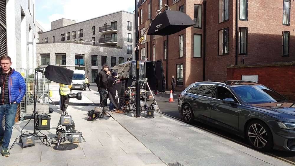 Large video crew with grip truck, lighting, and cameras on an urban set for a top corporate video production agency sugar land.